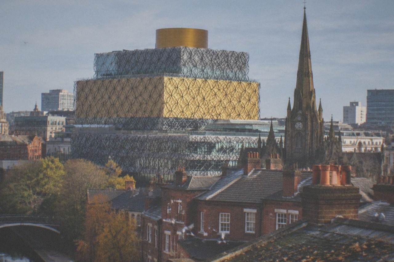 View over Birmingham city centre rooftops including the Library of Birmingham and St Philip's Cathedral
